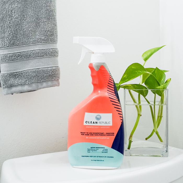 ready to use bottle of clean republic cleaner with a towel and plant leaves